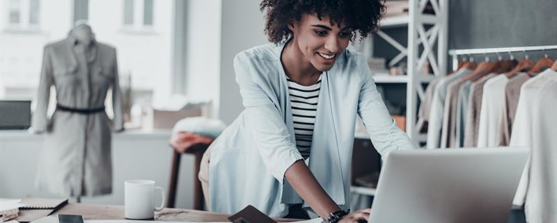 Businesswoman in shop on computer